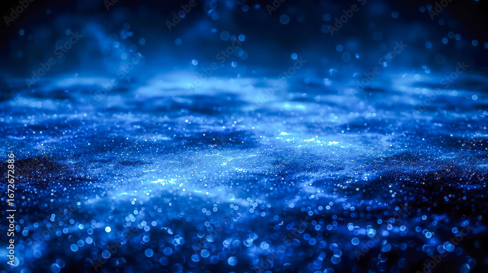 Fototapeta premium Abstract blue background with shimmering particles creating a cosmic atmosphere and depth