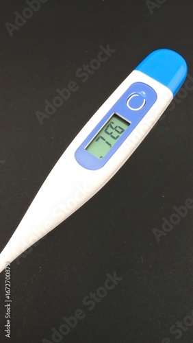 Digital thermometer on dark background