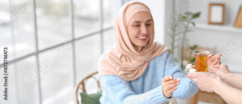 Young Muslim woman taking g...
