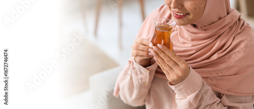 Young Muslim woman with gla...