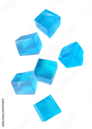 Yummy blue jelly cubes falling on white background
