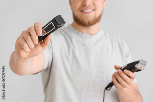 Young man with trimmers on ...
