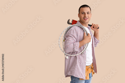 Smiling plumber with pipe w...