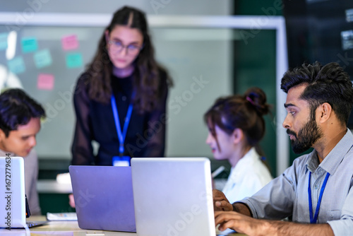 Slika na platnu A diverse group of professionals in a corporate workshop on AI development