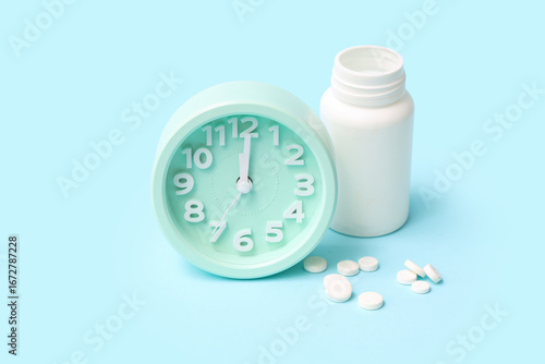 Alarm clock with bottle of ...