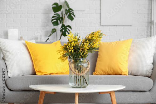 Vase with mimosa flowers on...