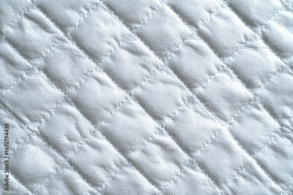 Naklejka premium Geometric pattern on white quilted textile