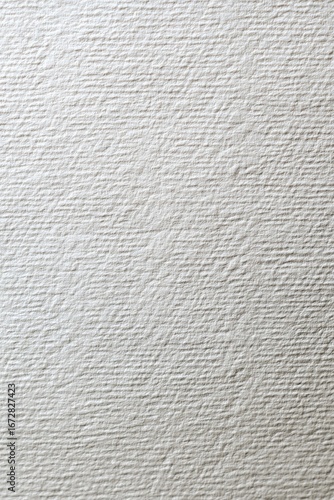 Close-up view of textured, off-white paper