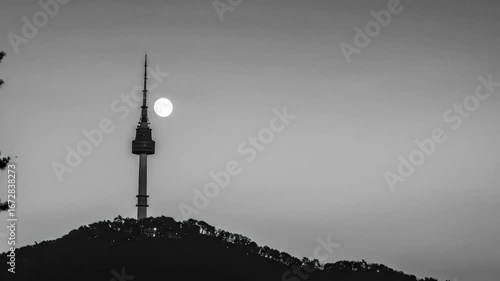 Tranquil time-lapse captures the ethereal moonset behind the iconic N Seoul Tower at dusk