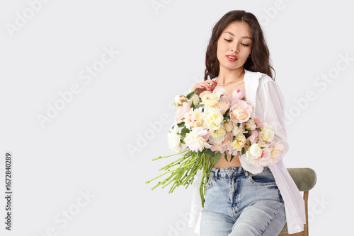 Young Asian woman with peon...