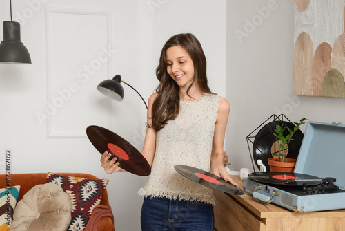 Young woman with vinyl disk...