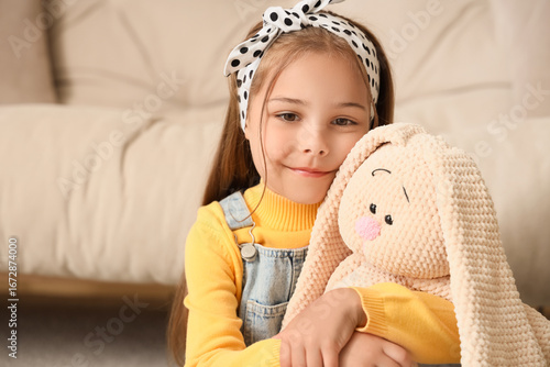 Cute little girl hugging to...