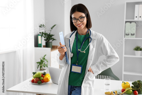 Female nutritionist with clipboard in office