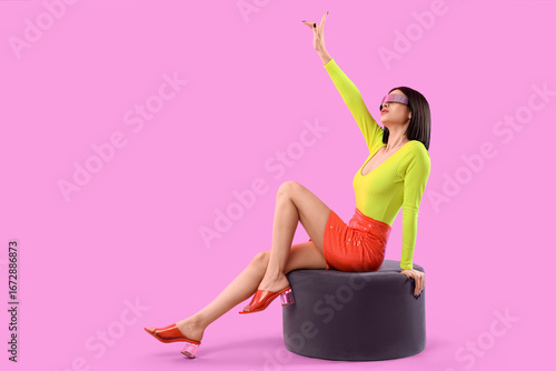 Fashionable woman in neon g...