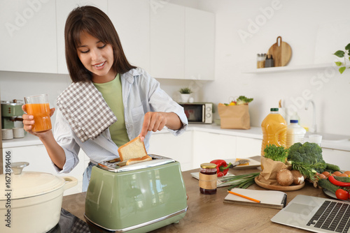 Young woman making toasts i...