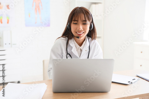 Female Asian doctor with he...