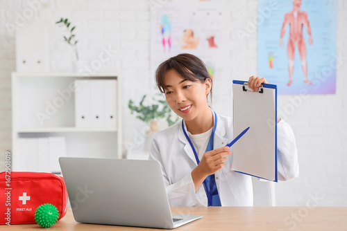 Female Asian doctor with bl...