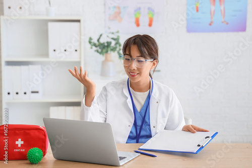 Female Asian doctor with cl...