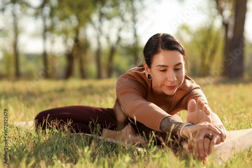 Young woman practicing yoga...