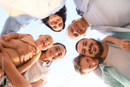 Portrait of big family in park at sunset, bottom view