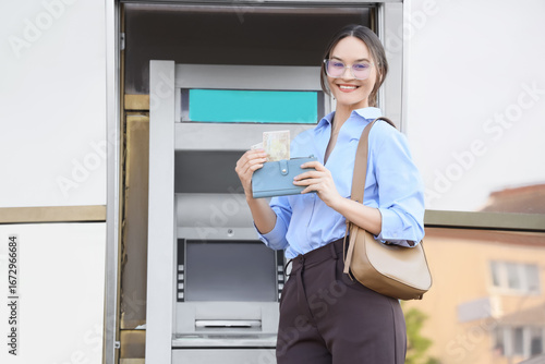 Businesswoman putting euro ...
