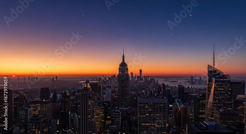 Panoramic cityscape view of New York City at sunrise, featuring the Empire State Building and other skyscrapers silhouetted against a vibrant orange and purple sky