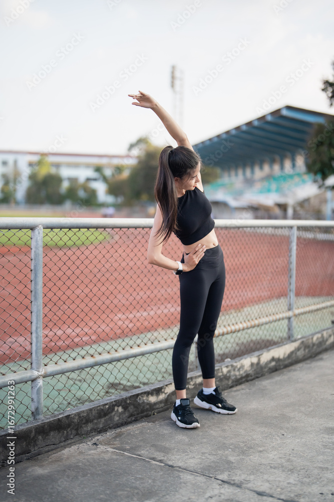 Active healthy asian woman exercising by running, jogging runner sports stadium during the morning healthcare and well being concept Active healthy asian woman exercising by running, jogging runner sports stadium during the morning healthcare and well being concept