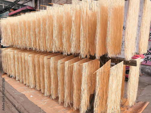 Fresh noodles drying in sun - traditional food preparation by farmers