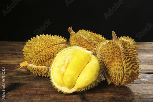 Golden Durian Fruits from Thailand - Fresh Tropical Exotic Fruit with Spiky Shell and Creamy Yellow Flesh on Wooden Background
