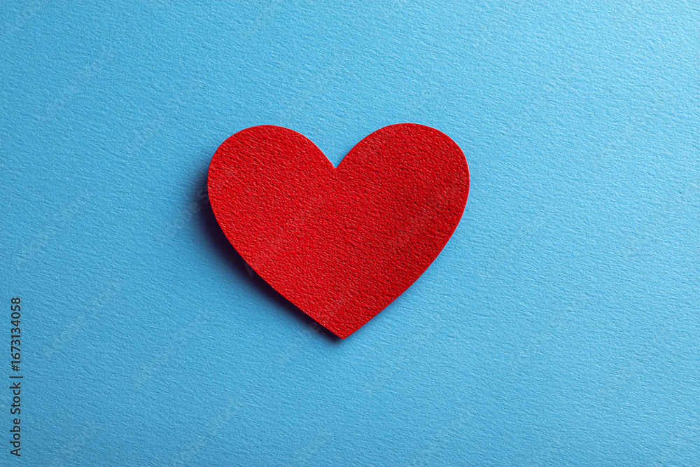 Obraz premium Red paper heart on blue background simple valentines design