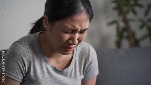 Woman at home suffering from menstrual pain