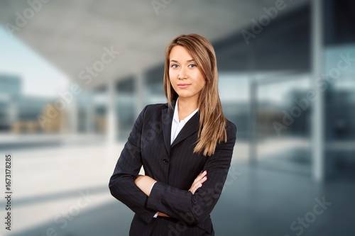 Successful professional businesswoman standing at office building. Free Download Successful professional businesswoman standing at office building. - GFXLoad