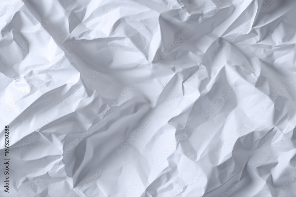 Fototapeta premium A close up view of crumpled white paper showing texture and shadows