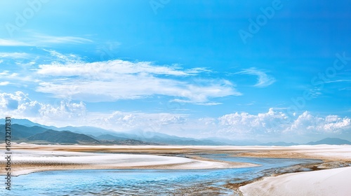 Fototapeta Naklejka Na Ścianę i Meble -  The azure sea, the white salt lake surface reflects the mountains and clouds in the distance, and the pure light blue hue creates a serene and relaxing atmosphere.