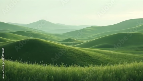 Rolling green hills create a vast landscape under an overcast sky. This natural, scenic view features soft, verdant terrain covered in grass, suggesting summer agriculture or a wild prairie expanse.