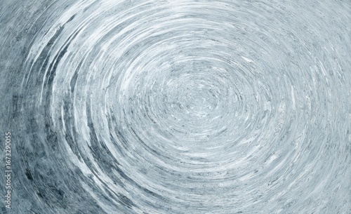 Circular ripples expand from a center point, creating a mesmerizing, textured pattern in cool, pale blue tones