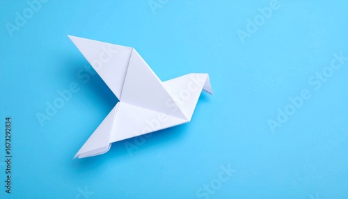 Free Download A simple paper origami boat sails on a blue background, a metaphor for travel and new ideas - GFXLoad