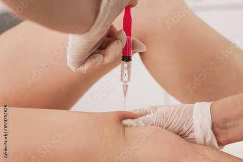 Injections of lipolytic into abdomen for weight loss and muscle definition close-up. doctor in sterile gloves inject lipolytic into hips, butt fat rolls on knees subcutaneously	