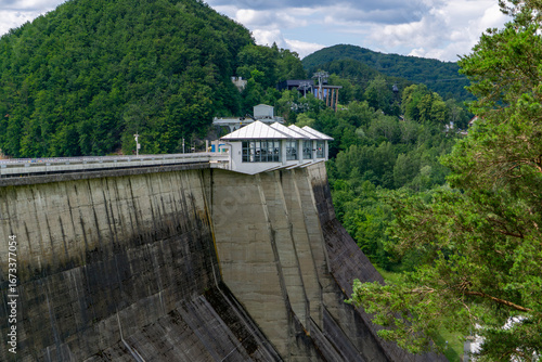 Fototapeta Naklejka Na Ścianę i Meble -  Solina dam in the Bieszczady Mountains, massive concrete hydroelectric structure surrounded by green forests and hills.