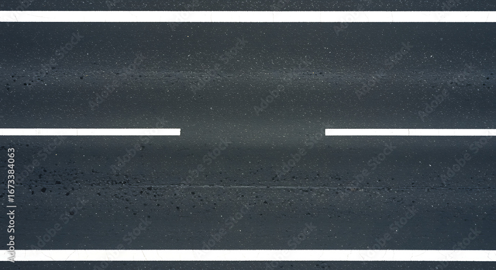 Fototapeta premium Aerial view of a dark asphalt road with clear white lane markings indicating traffic direction and separation on a bright day