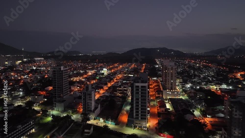 Wallpaper Mural Panoramic aerial fly over the illuminated city streets of Penha municipality with glowing buildings at night, Santa Catarina, Brazil. Torontodigital.ca
