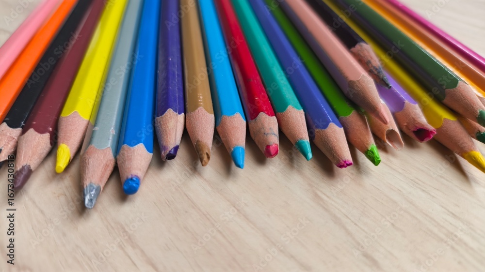 Education and creativity concept with color pencils on wooden background. Close-up photo with soft natural light and horizontal composition. Education and creativity concept with color pencils on wooden background. Close-up photo with soft natural light and horizontal composition.