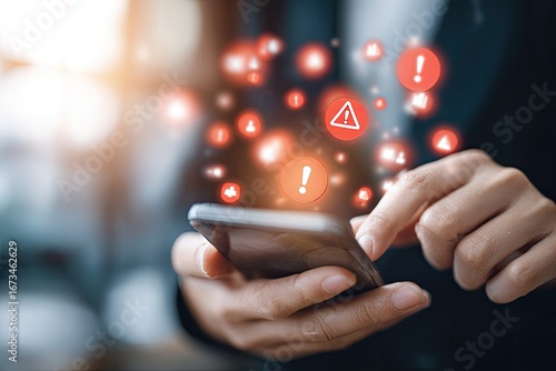 Hands holding phone with warning icons