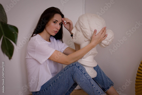 photo shoot of a girl in an interior studio with a plaster head