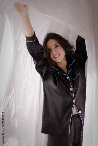 brunette girl in black silk pajamas