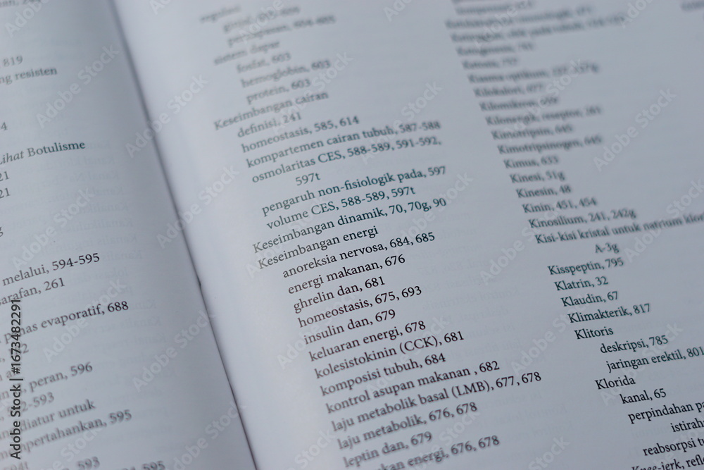 Obraz premium A close-up of an open medical textbook, showing detailed text and diagrams about human physiology and biology. This image represents study, education, research, and the journey of a medical student.