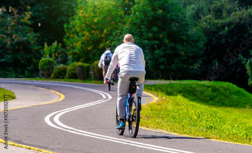 Wallpaper Mural Cyclist ride on the bike path in the city Park
 Torontodigital.ca