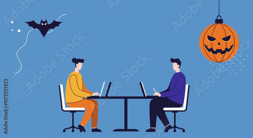 Two individuals diligently working on laptops at a desk, surrounded by Halloween decorations like a bat and jack-o'-lantern, blending work and holiday spirit.