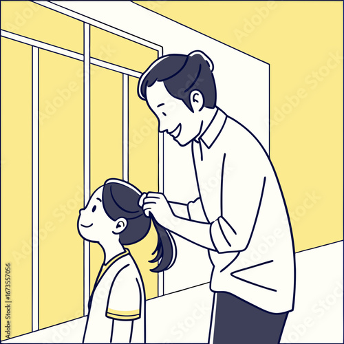 Father tying childs hair