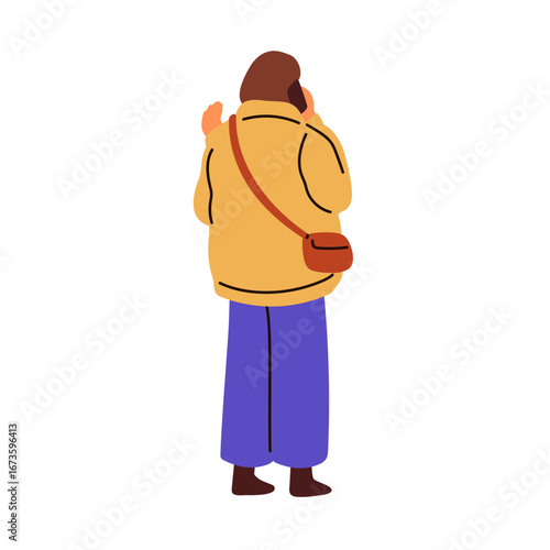 Woman standing, speaking on mobile phone outdoors. Young female holding smart...
